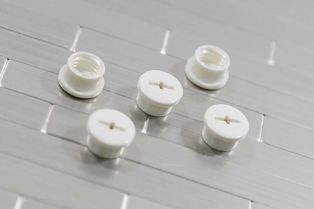 White bladder valve screws showing the slotted cap and the threaded inside