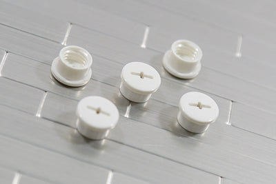 White bladder valve screws showing the slotted cap and the threaded inside